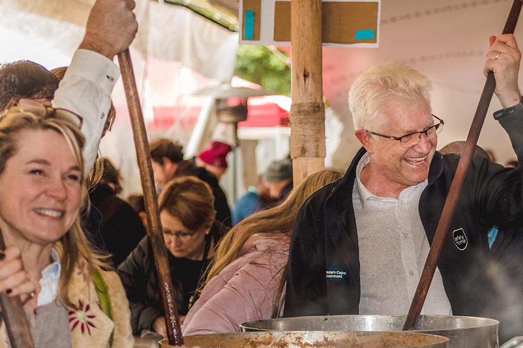 Cape Town Premier, Alan Winde, stirs soup with other volunteers on Mandela Day 2019