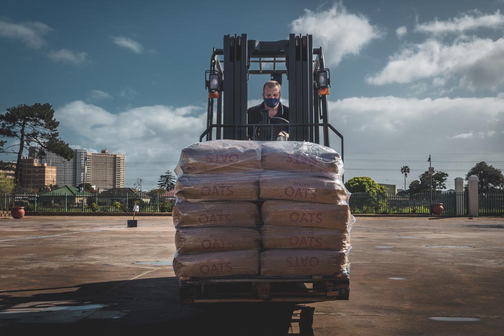 Goscor forklift loaded with oats driven by man across the Ladles of Love grounds