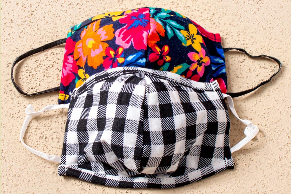 Facemasks sold to raise funds for Ladles of Love include this black and white checked mask & bright floral print mask